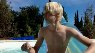 Blonde young boy naked at the pool